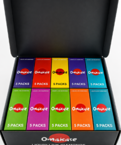 Omakase 2G Triple Tank All-in-One wholesale master case exterior in matte black showing Omakase logo with red circle, 50 PACKS text, 2.0G TRIPLE TANK ALL-IN-ONE product name, 2.0G net weight, and California cannabis compliance warning on the front panel.